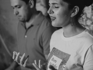 Woman singing with someone accompanying her on piano